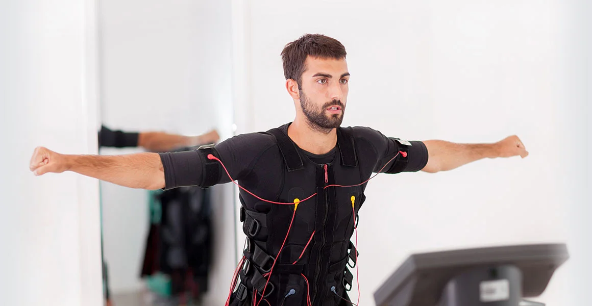 Person exercising in an EMS training suit